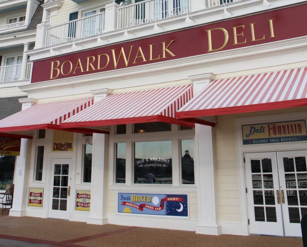 The front of the BoardWalk Deli with red and white striped window awnings.