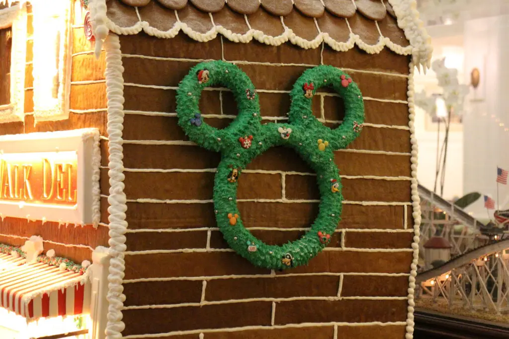 Mickey Mouse wreath on the side of a gingerbread house.