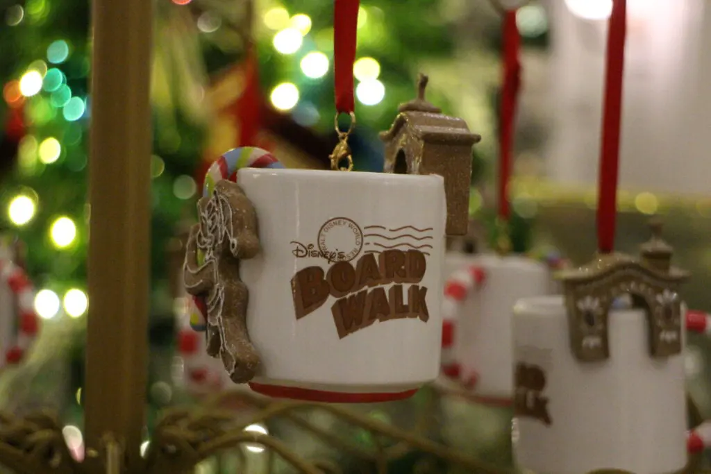 A mug ornament that says Disney BoardWalk with a gingerbread Donald Duck on it.