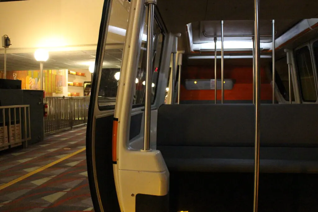 Inside the monorail at Disney with an open door looking out onto the Contemporary resort.