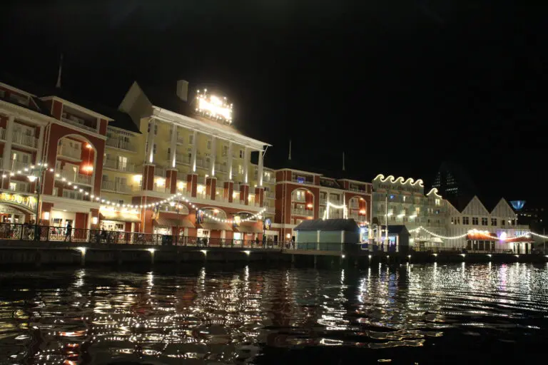 BoardWalk at Disney at night with lights reflecting on the water.