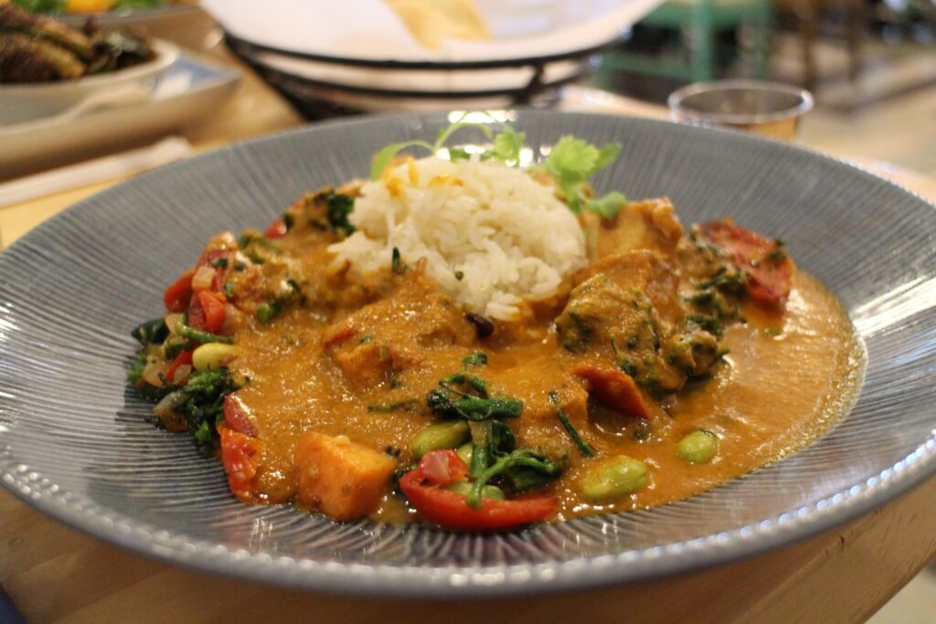 Olivia's Cafe curry pictured with rice, vegetables and sauce.