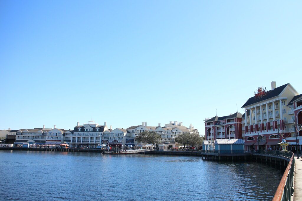 A lake with the Disney BoardWalk behind it beneath a blue sky.