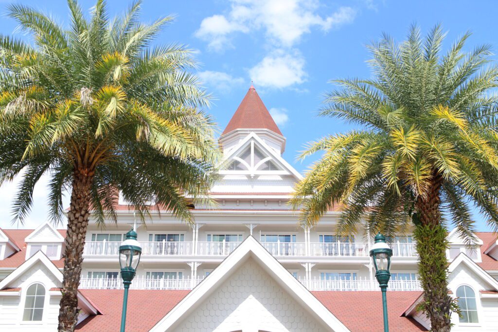 The front of the DVC Grand Floridian building, white with red roofs, and palm trees on either side, which has been more popular for ROFR DVC 2024 buybacks.