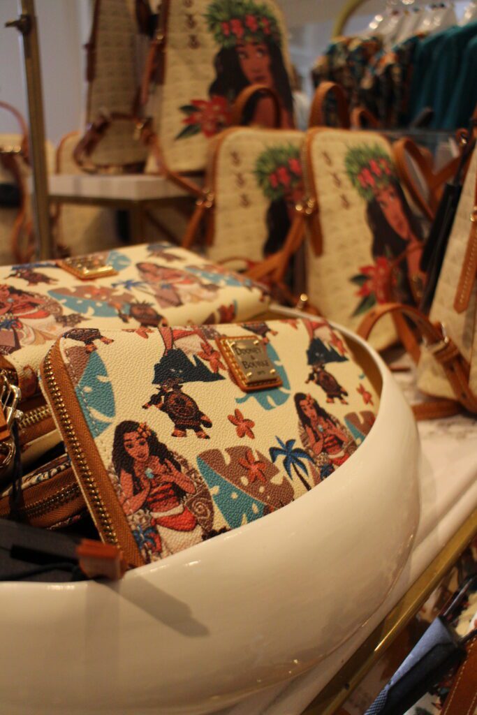 White Moana Dooney and Bourke print items with brown outline.