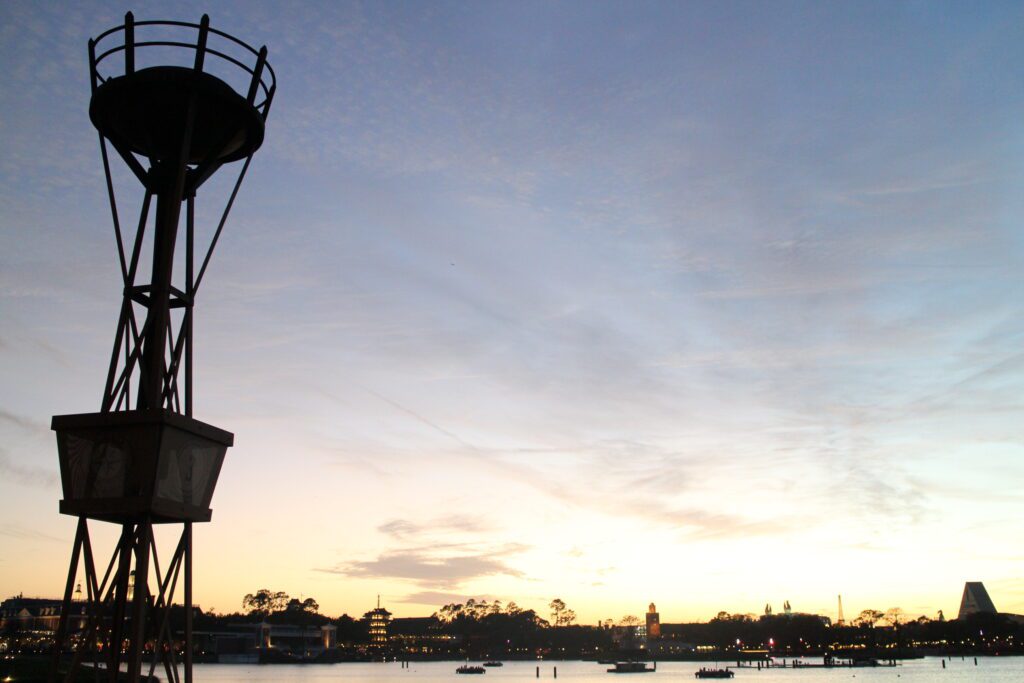 The Epcot World Showcase area during sunset with a silhouetted skyline.