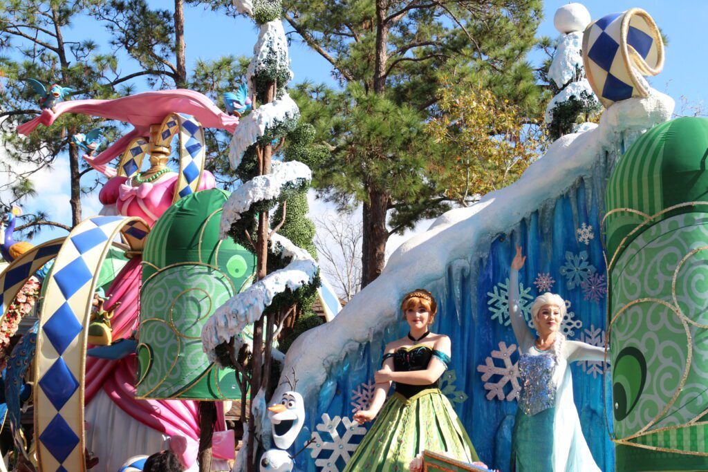 Elsa and Anna on a Festival of Fantasy parade float at Magic Kingdom. Frozen at Disney World.