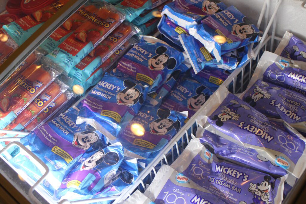 A freezer filled with wrapped Mickey ice cream novelties.