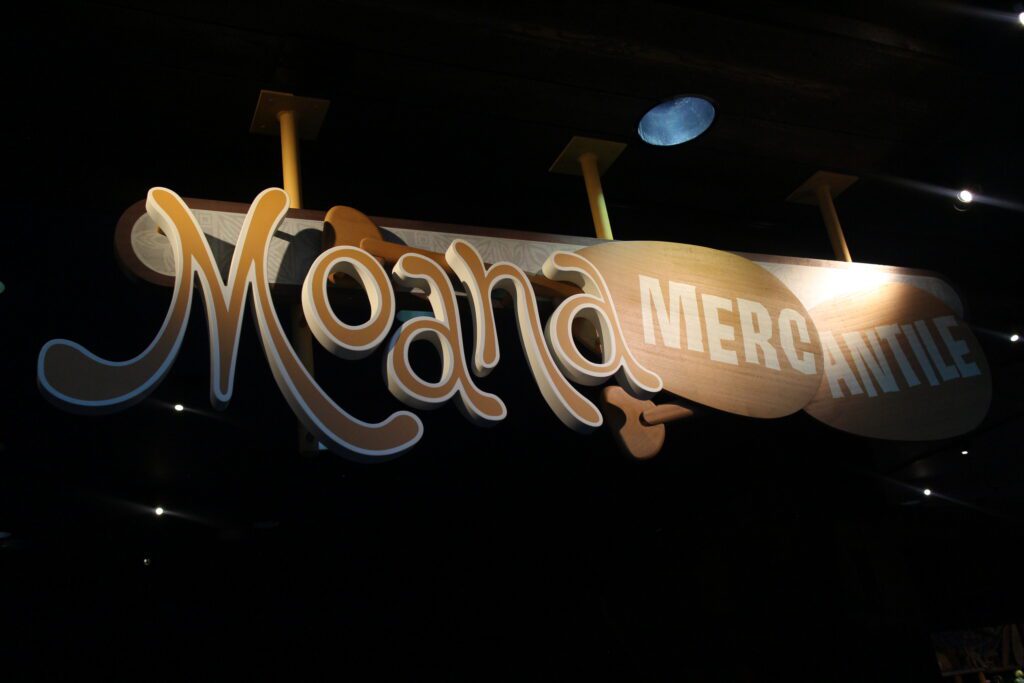 A tropical style, earth tone sign that reads Moana Mercantile.