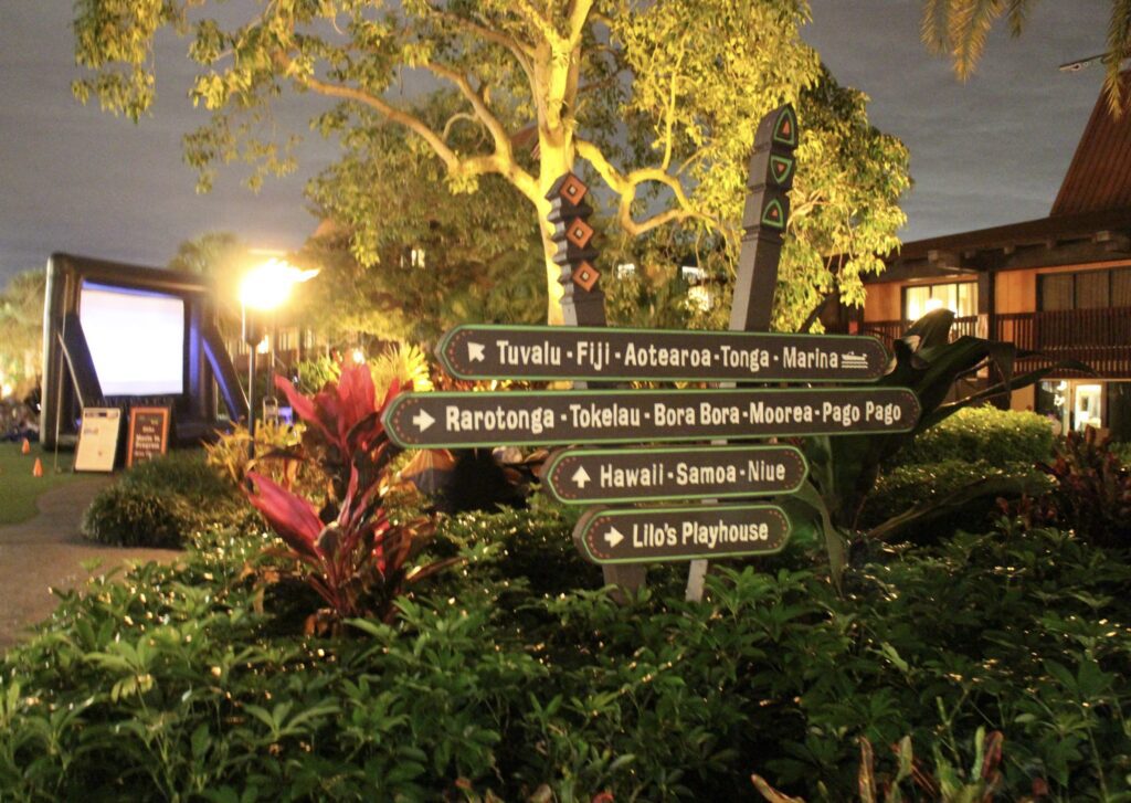 Polynesian directional signs at night.