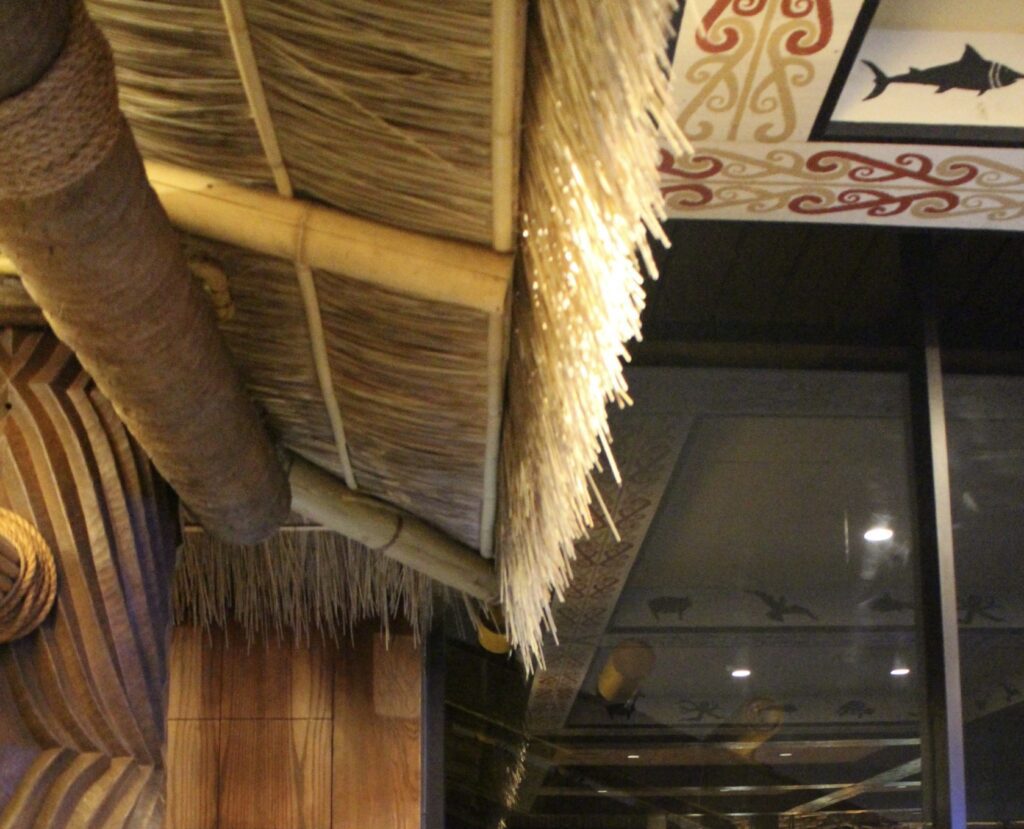 A thatched roof hangs over the bar at Tambu Lounge at Disney's Polynesian Village Resort.