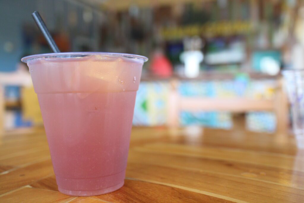 A cloudy, light pink Banana Cabana Caribbean Smuggler drink on a table.