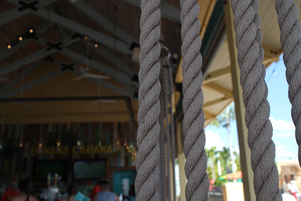 A rope seat closeup at Banana Cabana with the bar in the background.