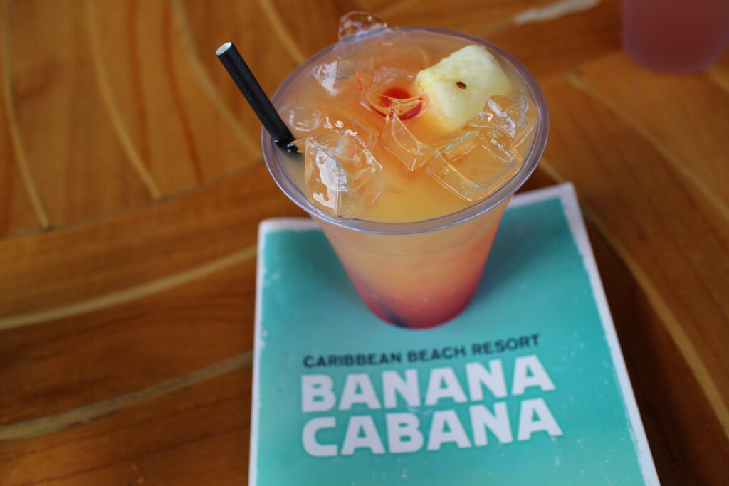 A tropical, colorful Banana Cabana drink sitting on a Banana Cabana menu.