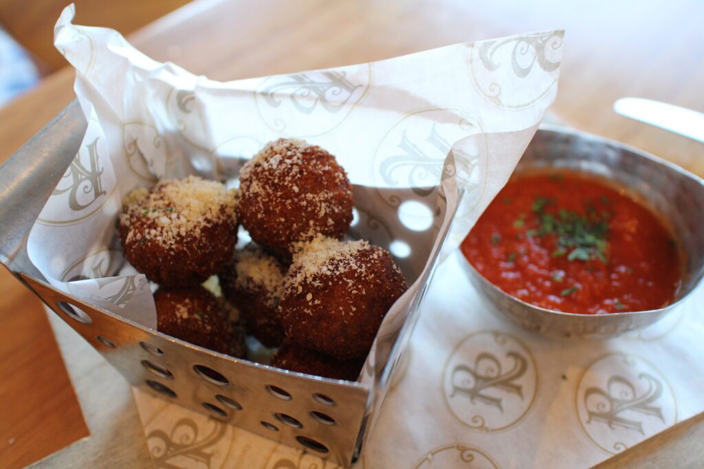 Bar Riva crispy Arancini with a side of red tomato sauce at Disney's Riviera Resort