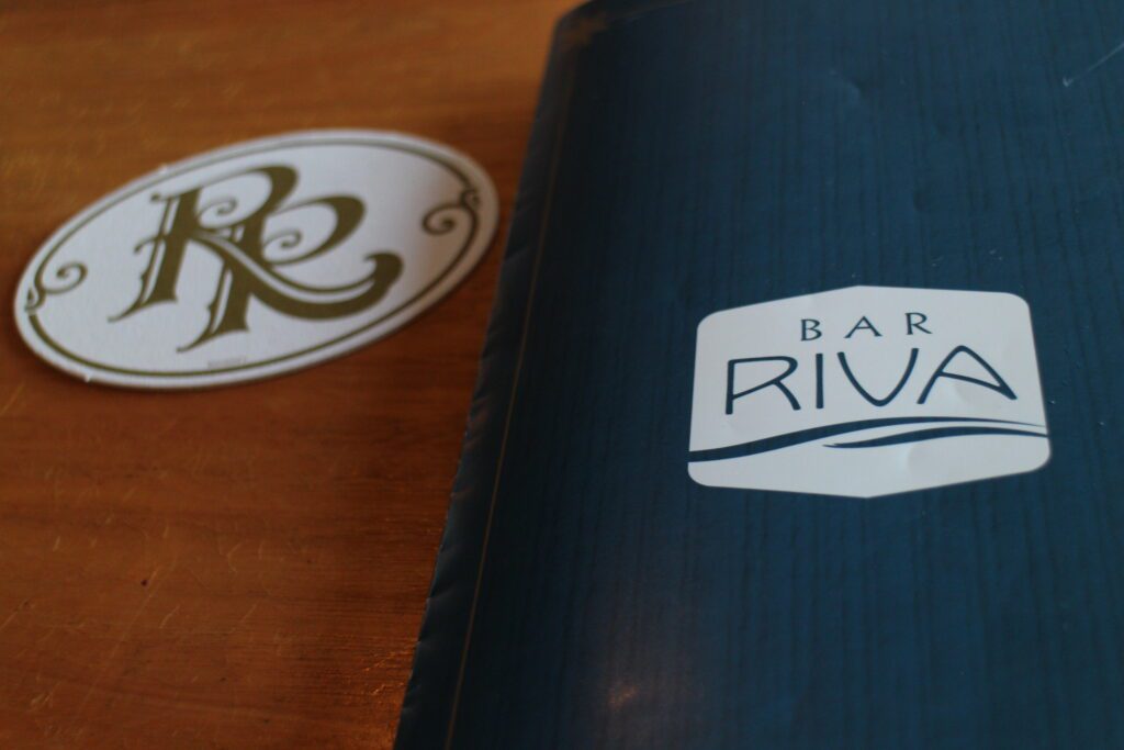 A Bar Riva menu on a table with an RR coaster