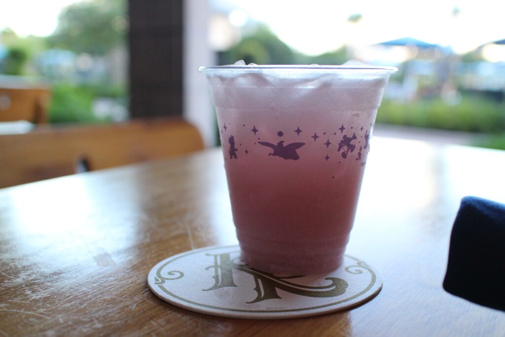 A light pink Bar Riva Hibiscus Coconut Refresher drink on a table at Disney's Riviera Resort.