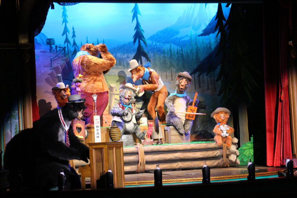 A musical bear act with instruments on a stage. Disney World news August 2024.