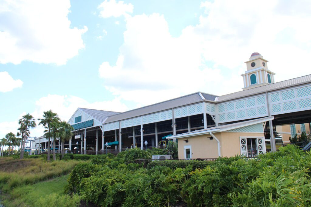 The main Disney Skyliner station at Disney's Caribbean Beach Resort with greenery surrounding it.