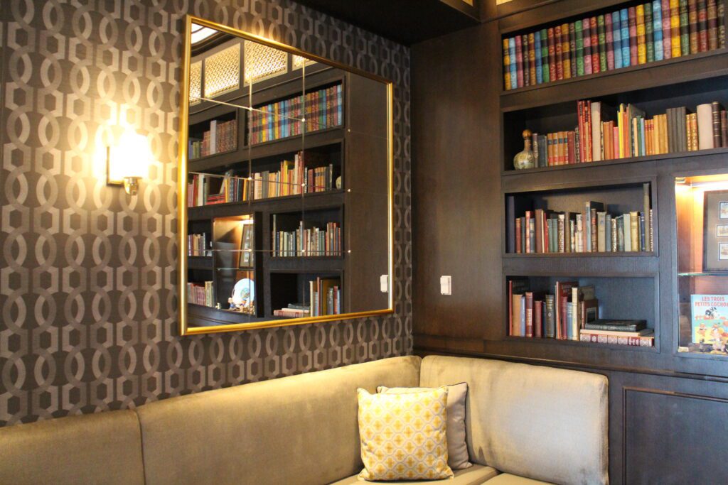 The Disney's Riviera Resort Voyageurs' Lounge gives a library setting feel with comfy couches, dark walls and lots of book shelves.