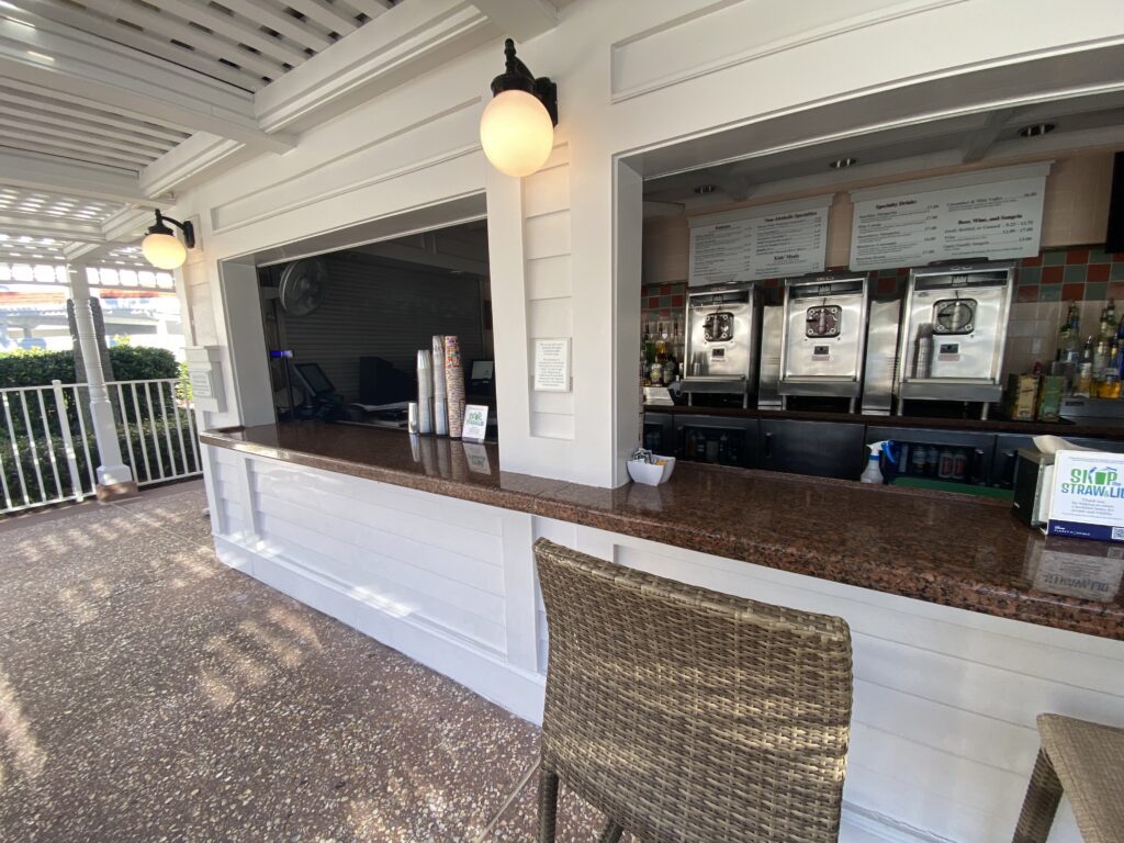 White Grand Floridian Disney World pool bar with a barstool in front of it.