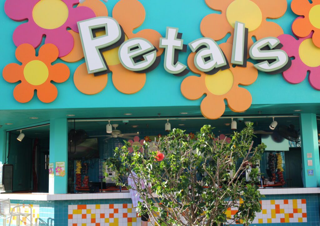 Petals Pool Bar colorful exterior with simple flower shapes and a walk up bar.