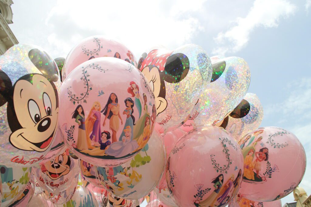 Disney balloon bunch in front of a blue sky with Mickey and Disney Princess designs | Selling DVC points