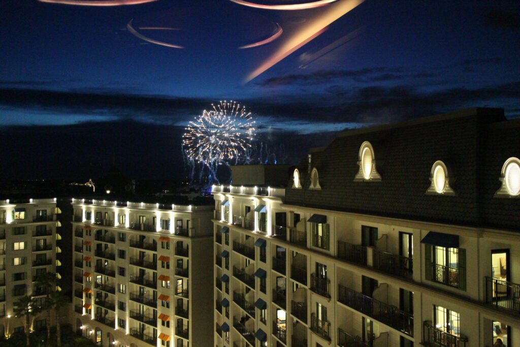 Topolino's Terrace lounge fireworks view over building top.