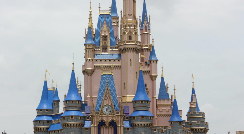 Disney World castle in front of a cloudy sky.