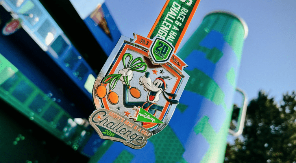 The 2025 Goofy Challenge medal  with a design of Goofy holding three medals on it.