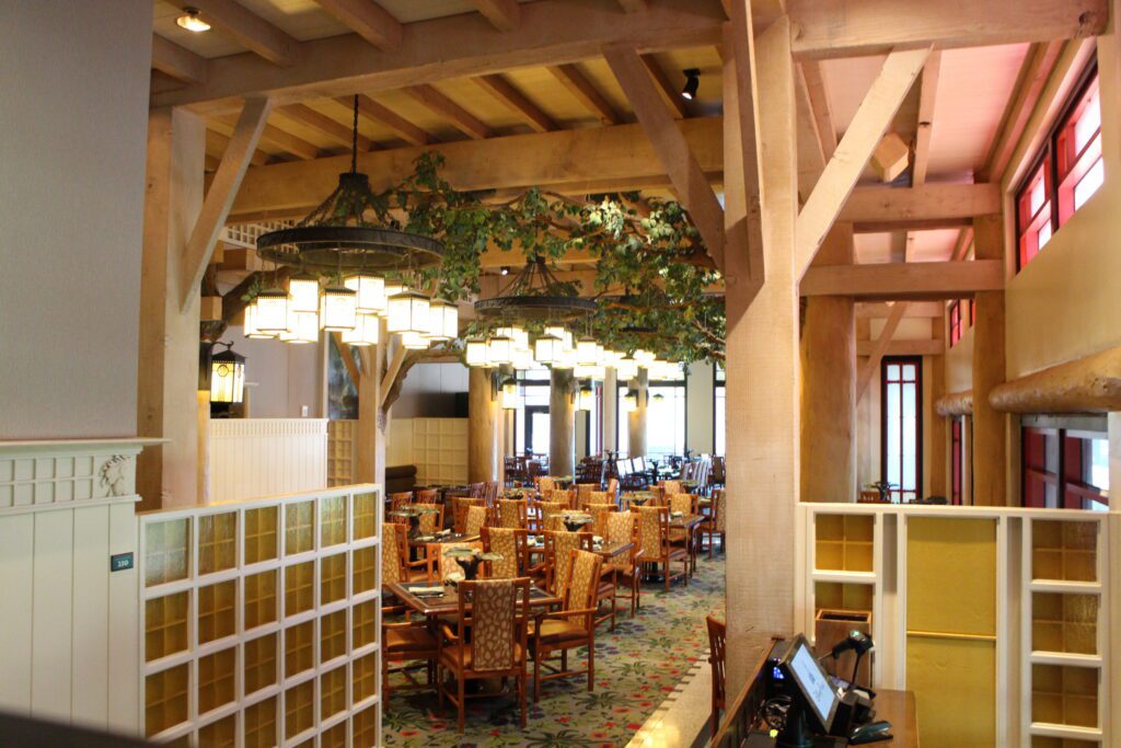 Story Book Dining at Artist Point restaurant venue with wooden chairs under an enchanted forest ceiling.