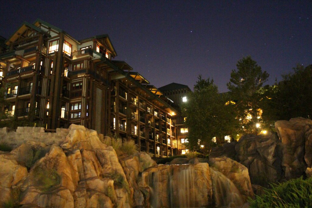 Wilderness Lodge falls with rocks in front of a night sky with stars.