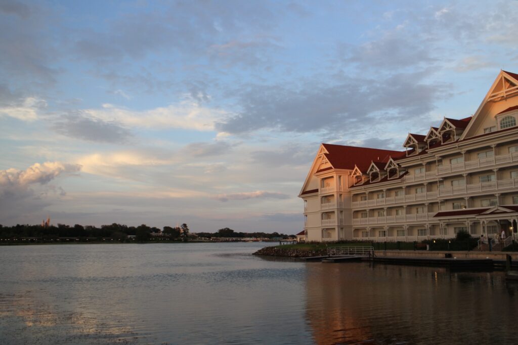 Grand Floridian marina at golden hour with Cinderella Castle off in the distance.