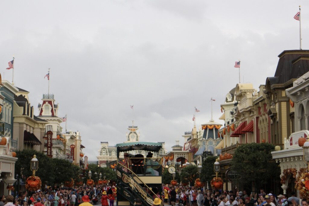 Main Street at Disney World with characters on a two story vehicle.