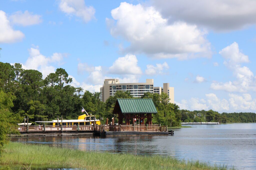 A boat dock with a large yellow boat docked.