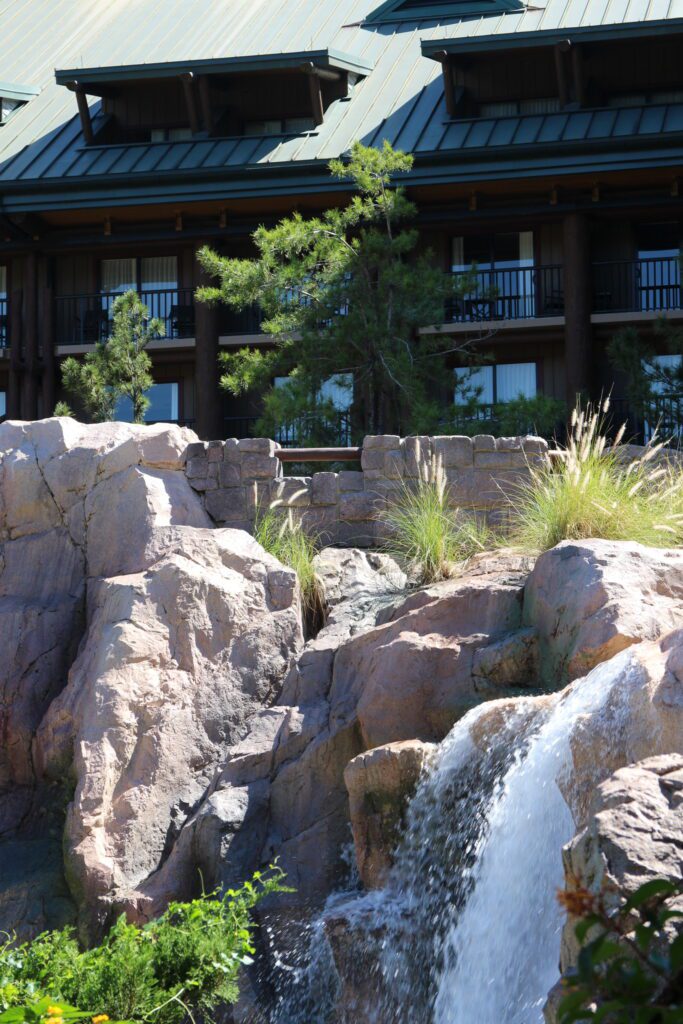 A water fall at Wilderness Lodge with rustic surroundings.